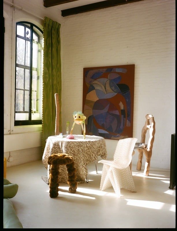A styled event set with a dressed table and vintage furniture in the daylight