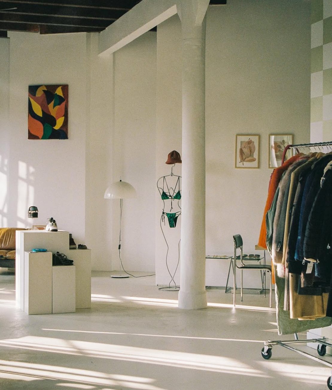 A shoot in progress — clothing rack and set in the open space